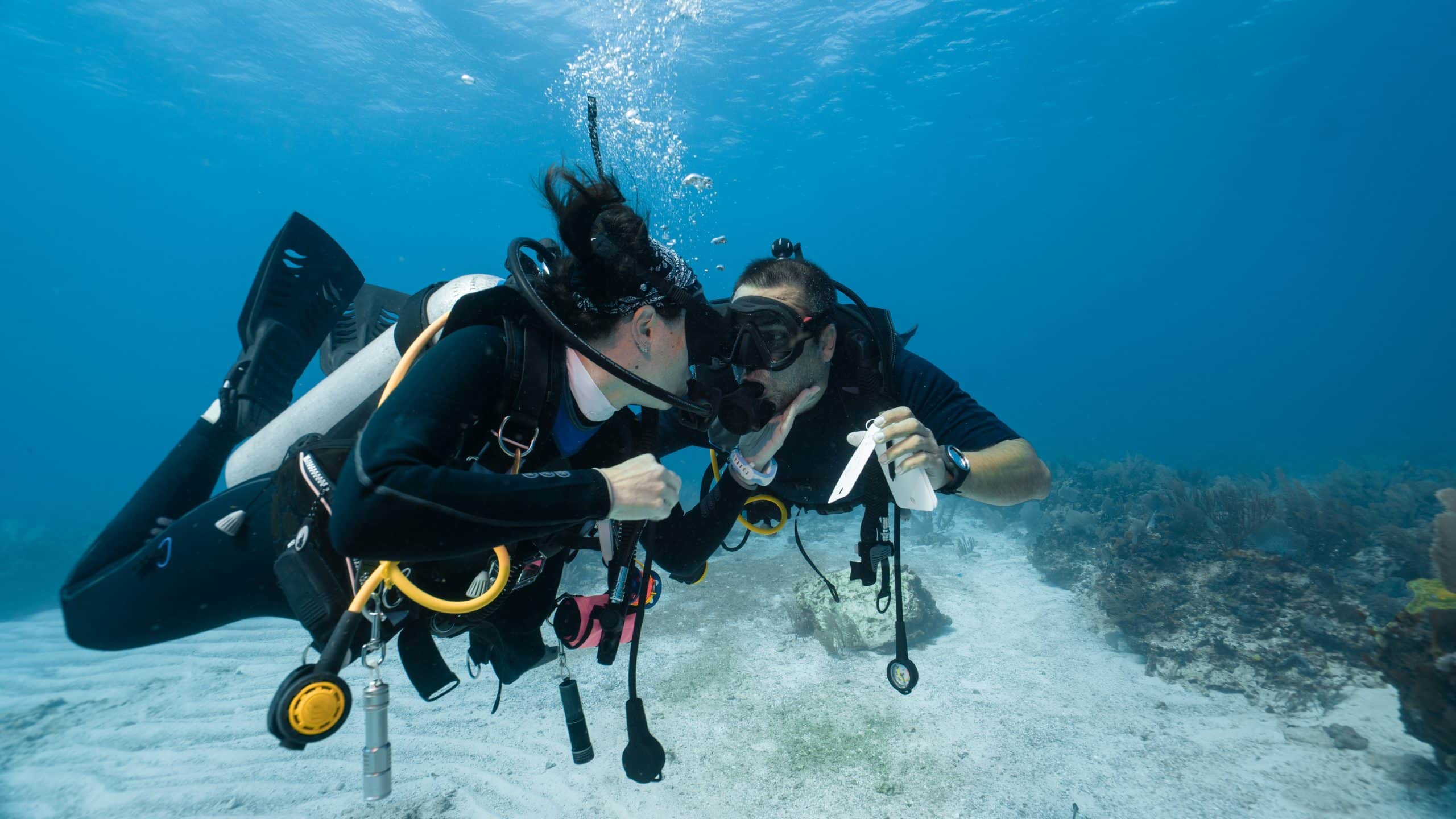 Man proposing marriage underwater to his fiancee