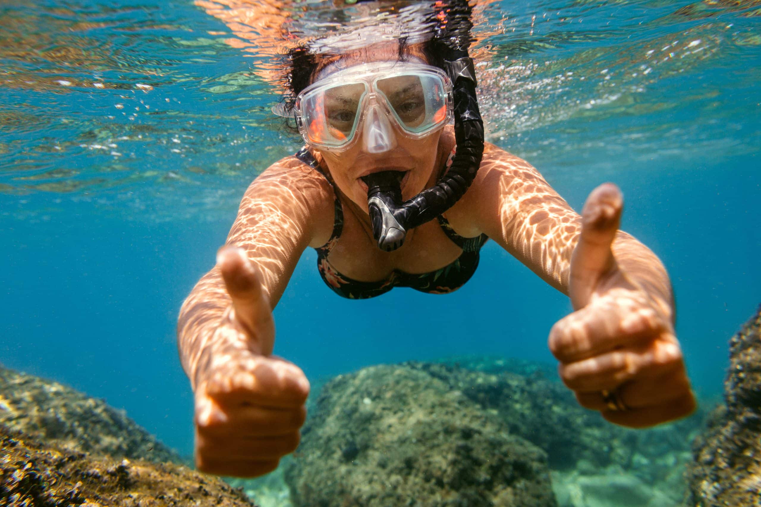 Woman snorkelling under water.