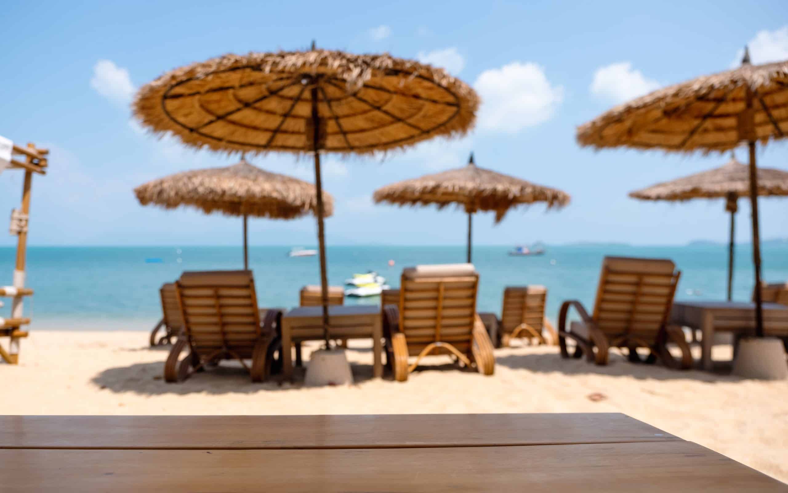 Wooden table and chairs at tropical beach cafe