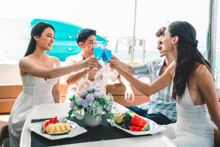 Caucasian couple relax fun with luxury party drinking champagne together while catamaran yacht boat