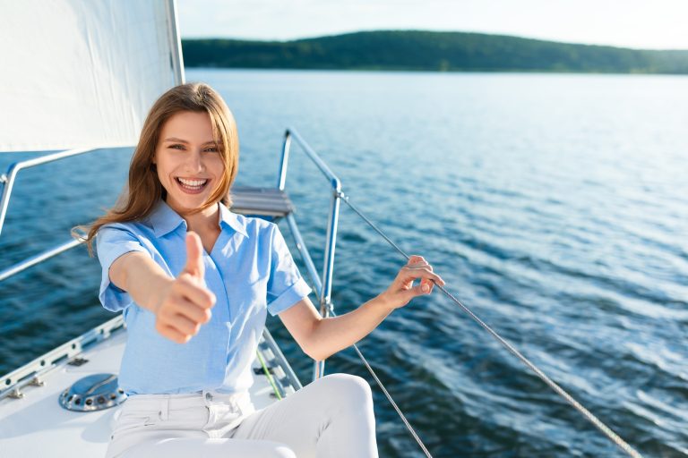 Cheerful Woman Sailing On Yacht Gesturing Thumbs-Up Approving Sailboat Tour