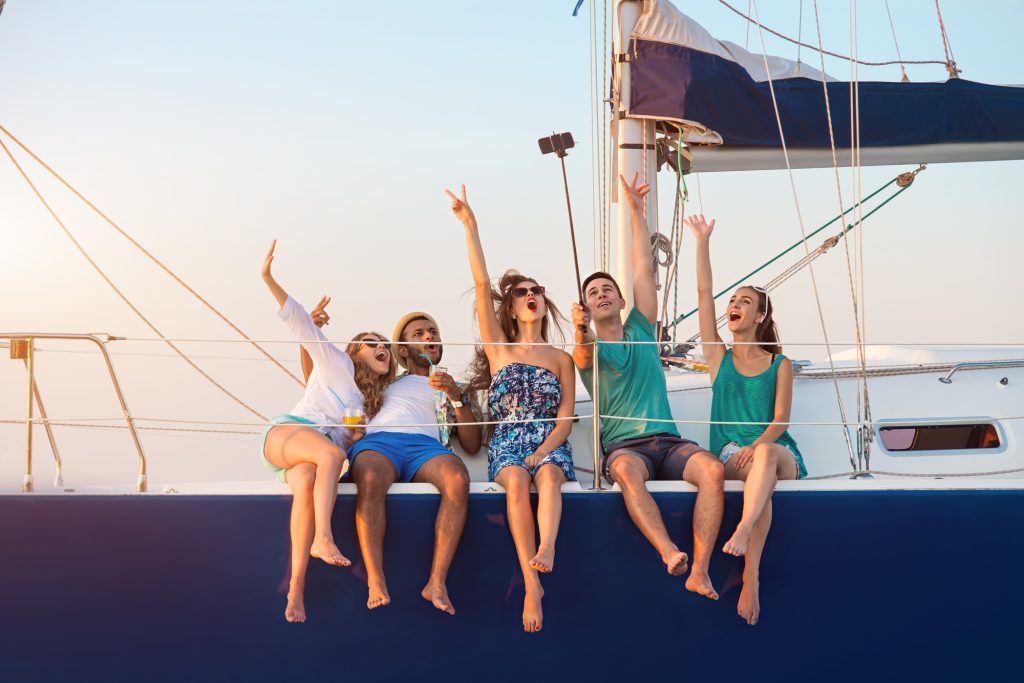 Men with women on yacht.