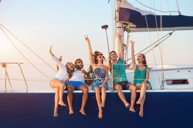 Men with women on yacht.