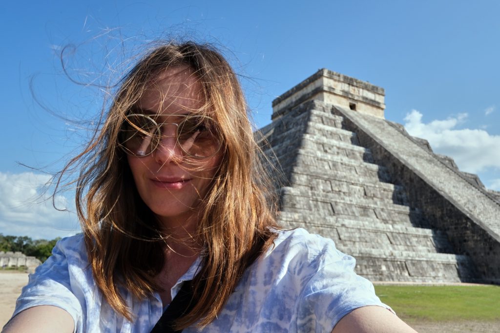 Woman taking selfie near temple of Kukulcan